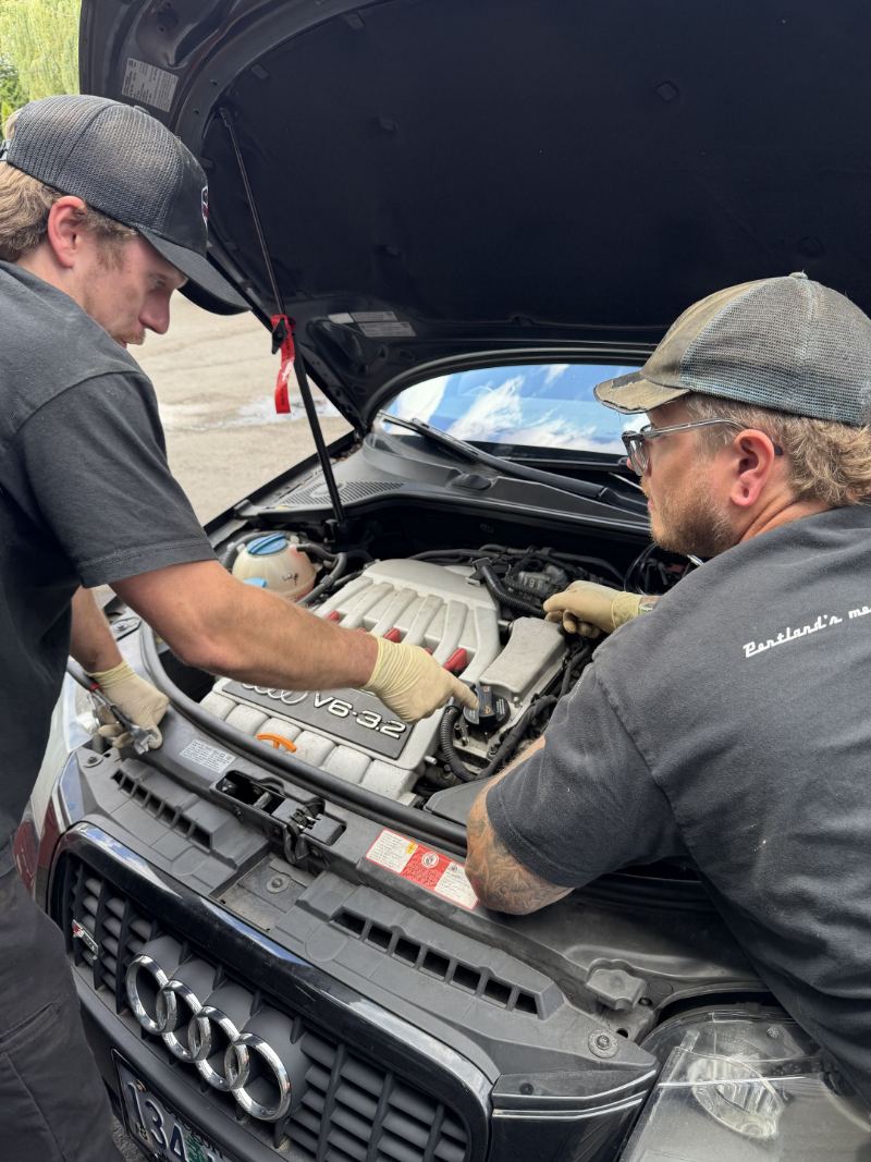 Two Trafton's technicians working on an Audi 3.2 V6 engine