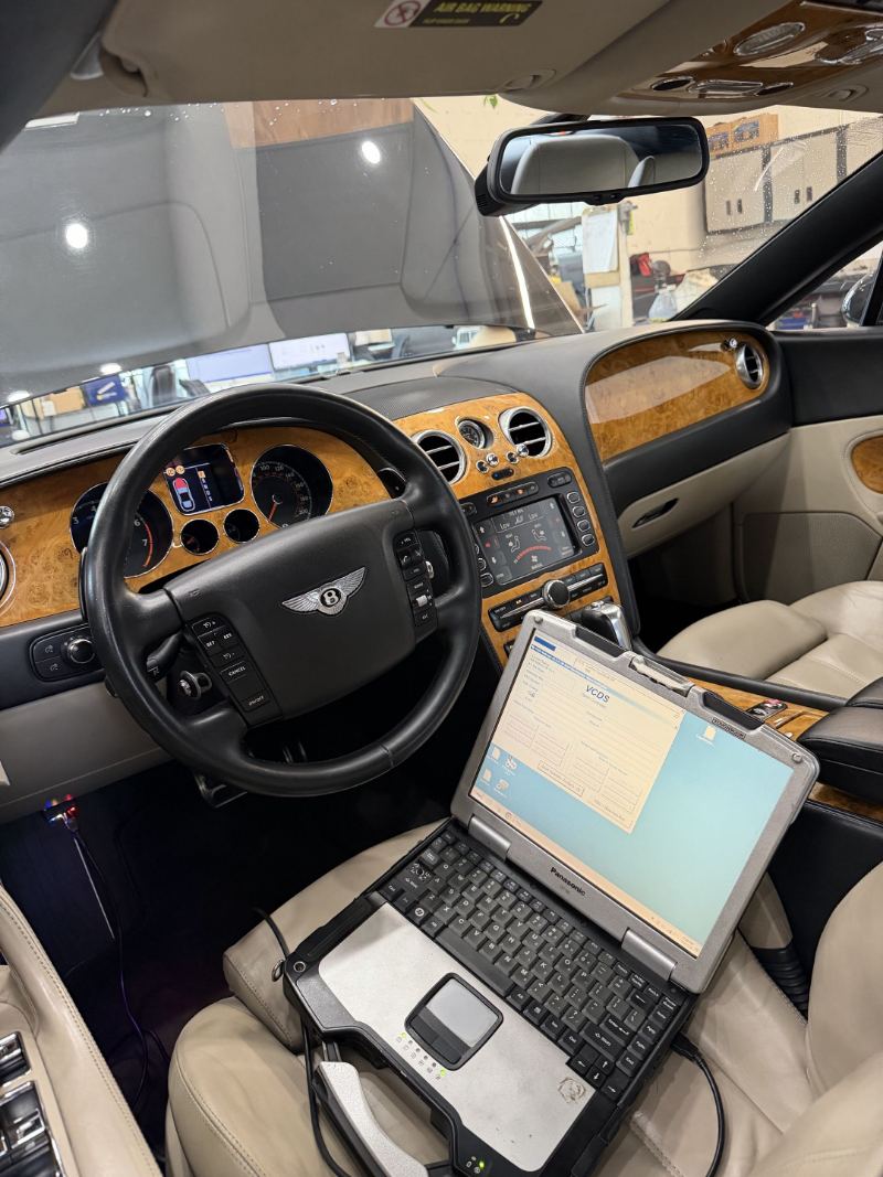 Diagnostic laptop running VCDS inside a Bentley Continental Flying Spur