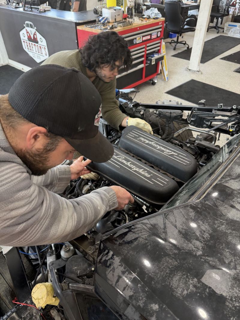 Two Trafton's technicians servicing a Lamborghini V10 engine in Portland, Oregon
