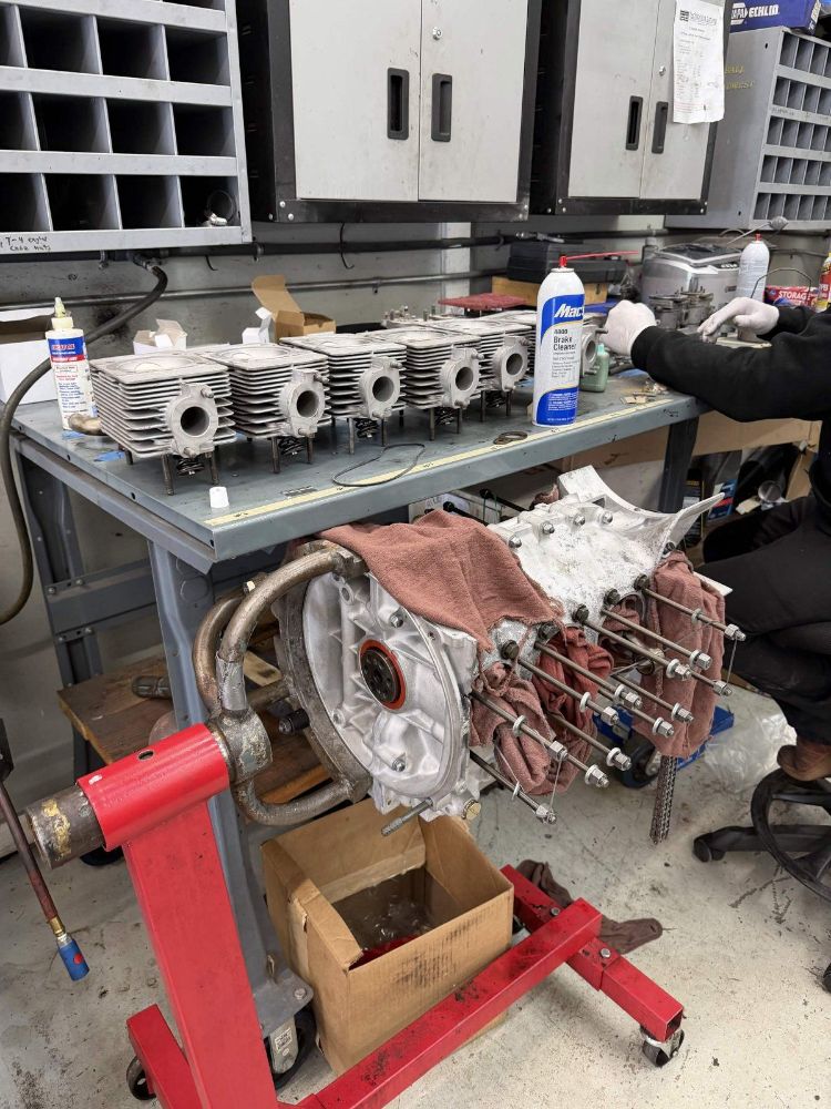 The air-cooled flat-six engine from the 1966 Porsche 911 torn down and being rebuilt on the bench at Trafton's