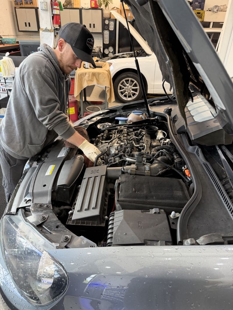 Trafton's technician servicing a modern Volkswagen engine in Portland, Oregon